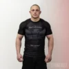 Athlete wearing Stonebelt Legion short sleeve BJJ rashguard in black with sublimated eagle design