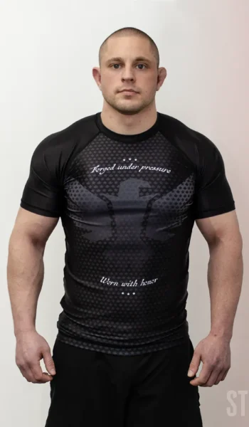 Athlete wearing Stonebelt Legion short sleeve BJJ rashguard in black with sublimated eagle design