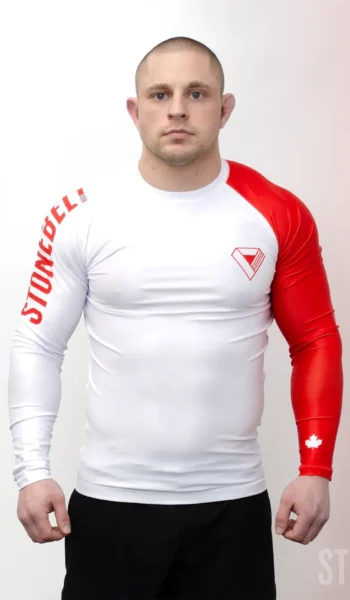 Athlete wearing Stonebelt Heritage long sleeve BJJ rashguard in white and red showing compression fit and full sleeve coverage