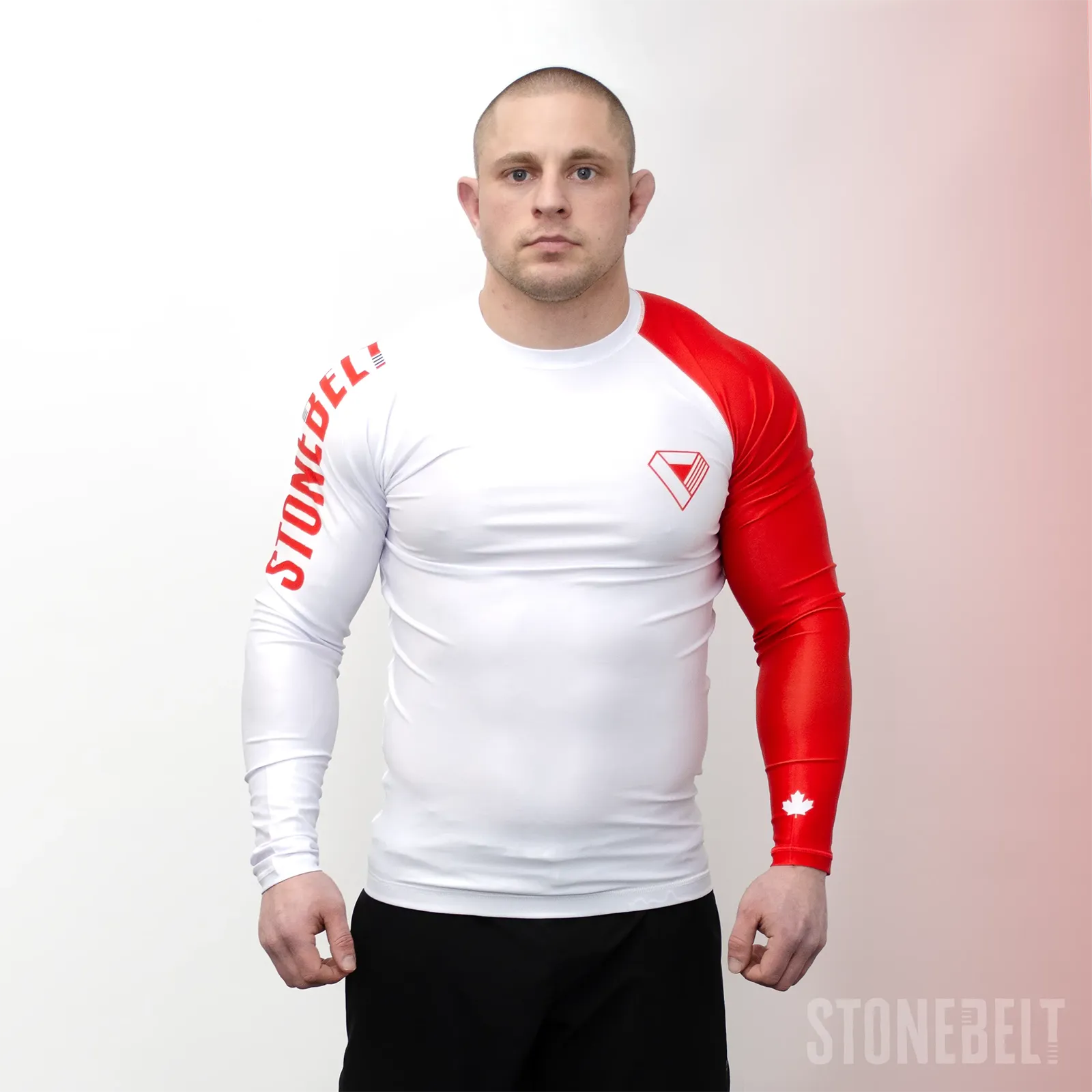 Athlete wearing Stonebelt Heritage long sleeve BJJ rashguard in white and red showing compression fit and full sleeve coverage