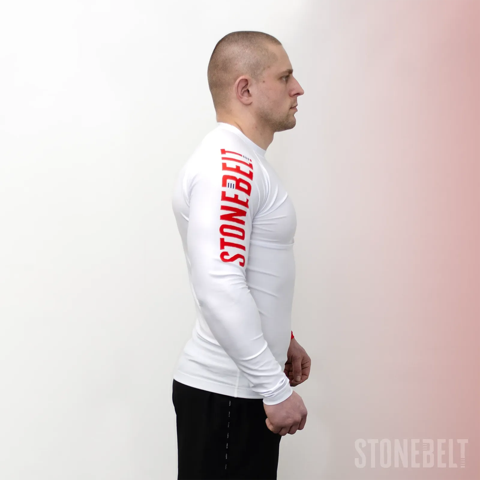 Side profile of Stonebelt Heritage long sleeve rashguard showing Stonebelt arm branding and compression sleeve fit