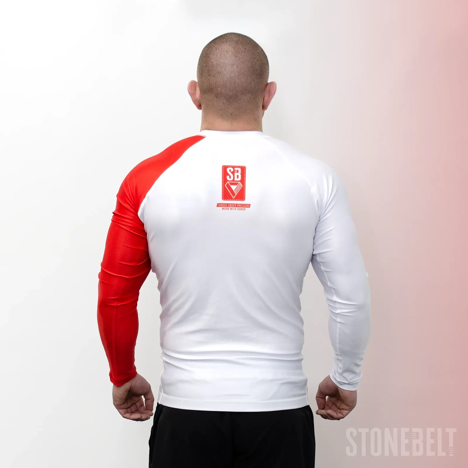 Back view of Stonebelt Heritage long sleeve BJJ rashguard showing SB badge and red left sleeve panel