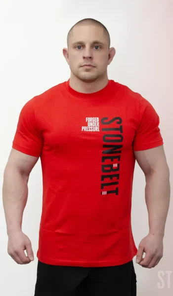 Athlete wearing Stonebelt Classic Logo Tee in red with vertical Stonebelt branding and Forged Under Pressure text
