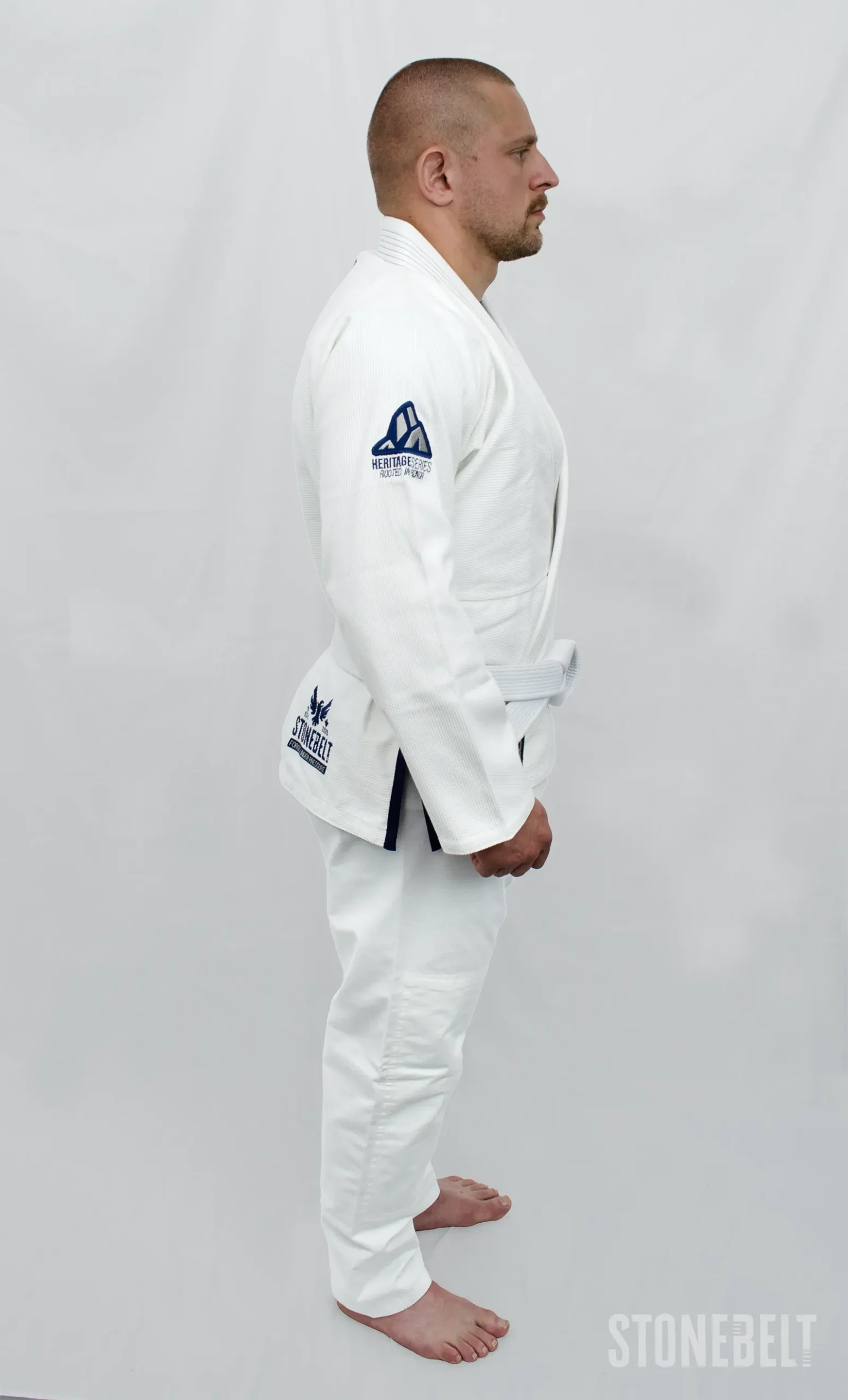 Stonebelt Heritage BJJ Gi in white, right side view on model, showing Heritage Series shoulder embroidery