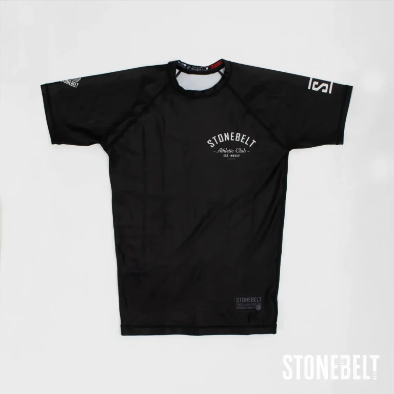 Stonebelt Athletic Club short sleeve BJJ rashguard in black, flat front view with chest and sleeve logos