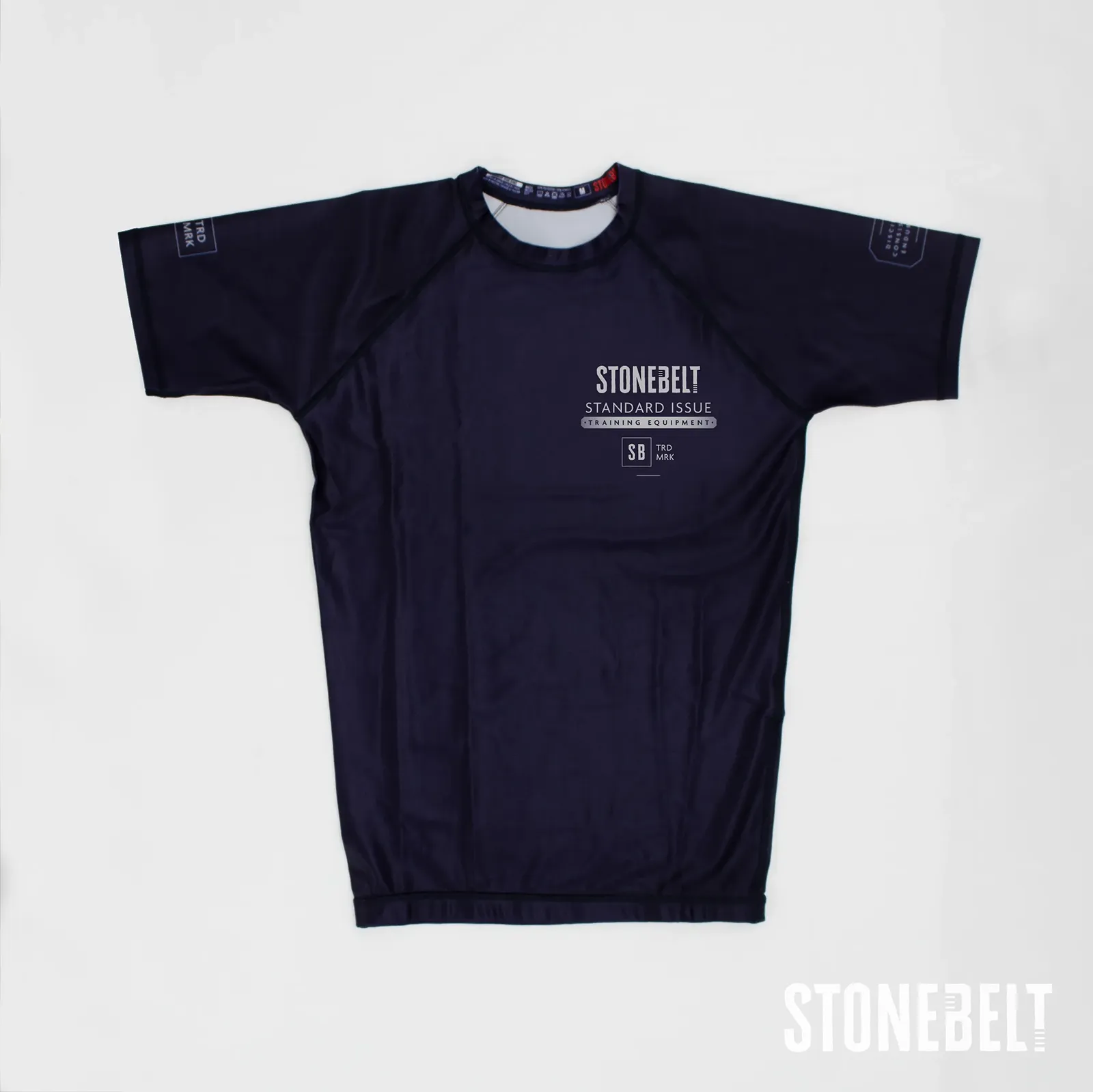Stonebelt Standard Issue short sleeve BJJ rashguard in navy, flat front view with chest and sleeve graphics