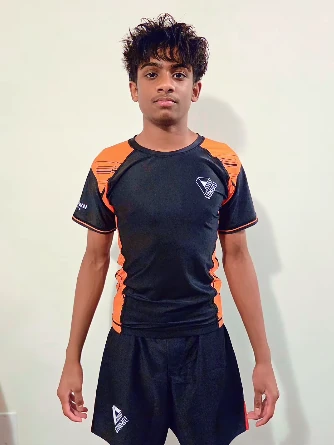 Delwin Jerard wearing an orange and black Stonebelt rashguard